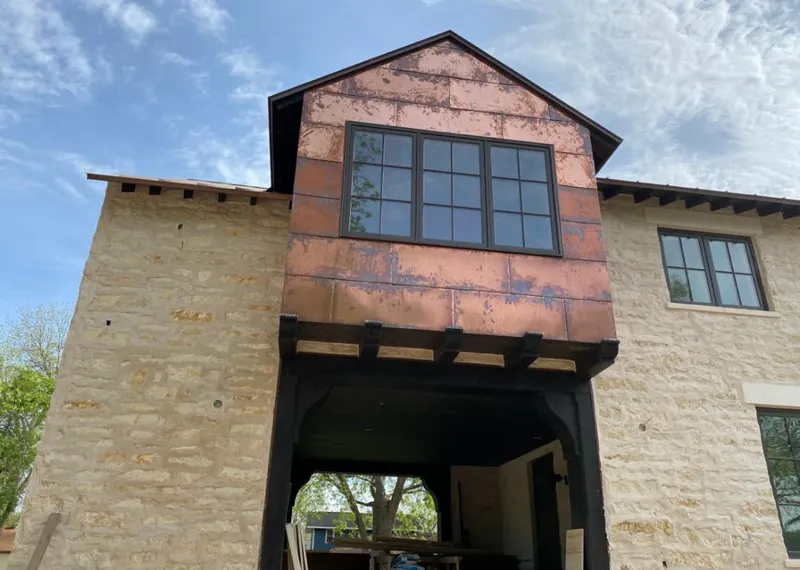 Copper metal panel facade on a stone building for Skylight Installation in Green Valley